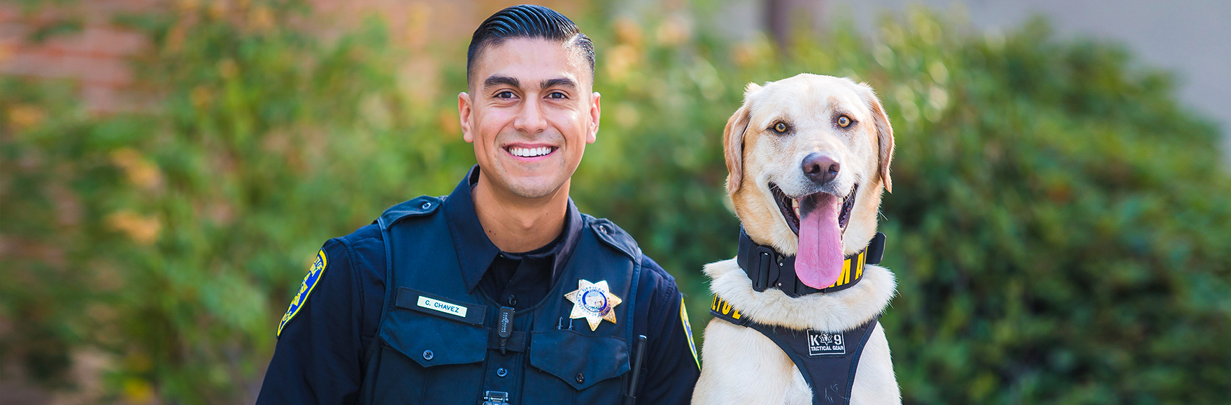 Officer Chavez smiles with K-9 Max